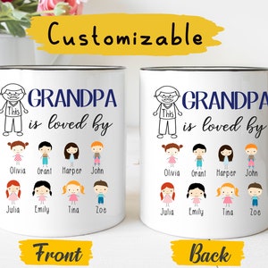 May include: White ceramic mug with a black handle. The mug has a black outline and the text "GRANDPA is loved by" in blue. Below the text are drawings of children with names underneath. The back of the mug has the same design.