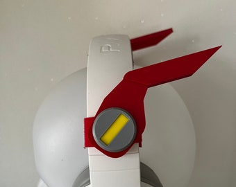 May include: White gaming headset with red and grey earpiece covers. The earpiece covers have a yellow stripe.
