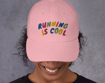 May include: Pink baseball cap with the text "RUNNING IS COOL" embroidered in colorful letters.