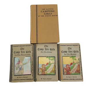 May include: Four vintage paperback books with brown covers. The top book is titled "The Banner Campfire Girls at The White House". The three books below are titled "The Camp Fire Girls In The Mountains", "The Camp Fire Girls On The Farm", and "The Camp Fire Girls In The Woods".