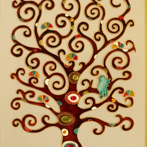 May include: A stained glass artwork depicting a stylized tree with a blue bird perched on a branch. The tree has a brown trunk and branches with swirling patterns and is decorated with colorful gems. The background is a cream color.