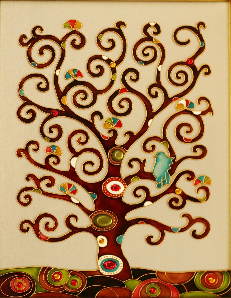May include: A stained glass artwork depicting a stylized tree with a blue bird perched on a branch. The tree has a brown trunk and branches with swirling patterns and is decorated with colorful gems. The background is a cream color.
