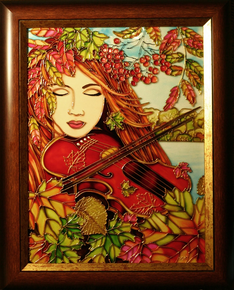 Pu&ograve; includere: Un'opera d'arte in vetro colorato che raffigura una donna con i capelli rossi che suona il violino. La donna &egrave; circondata da foglie autunnali in tonalit&agrave; di rosso, arancione, giallo e verde. Lo sfondo &egrave; un cielo azzurro chiaro con nuvole bianche.