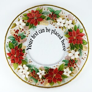 May include: A clear glass plate with a gold rim, decorated with red poinsettias, white flowers, green leaves, and red berries. The text "Your text can be placed here" is in the center of the plate. A festive, decorative item.
