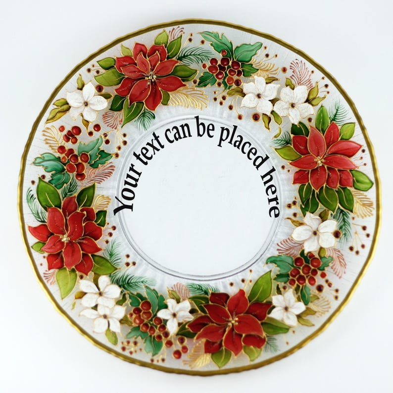 May include: A clear glass plate with a gold rim, decorated with red poinsettias, white flowers, green leaves, and red berries. The text "Your text can be placed here" is in the center of the plate. A festive, decorative item.