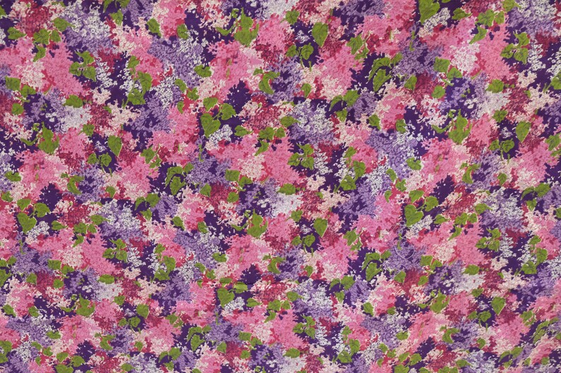 May include: A fabric with a floral pattern featuring pink, purple, and green flowers. The flowers are clustered together and create a busy, colourful design.