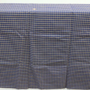 May include: A navy blue fabric with a fine yellow grid pattern. The fabric is folded in half and laid flat on a white surface.