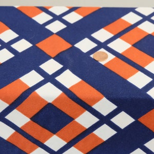 May include: Blue, white, and orange geometric fabric with a repeating pattern of squares and rectangles.