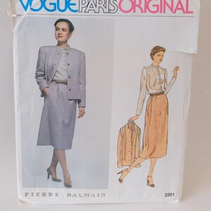 May include: Vogue Paris Original sewing pattern for a skirt and jacket set by Pierre Balmain. The pattern features two illustrations of women wearing the outfit. The pattern number is 2201.