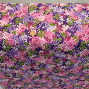 May include: Purple, pink and green floral fabric with a white background. The fabric has a small-scale print of flowers and leaves.