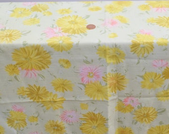 May include: A cream-colored fabric with a repeating pattern of yellow and pink flowers. The flowers are stylized and have a vintage look.