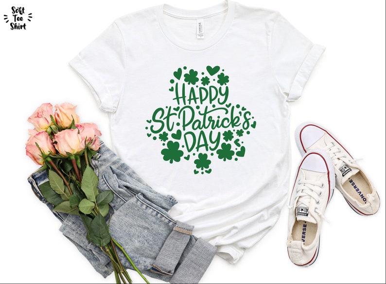 May include: White t-shirt with green shamrock design and the text "Happy St. Patrick's Day".