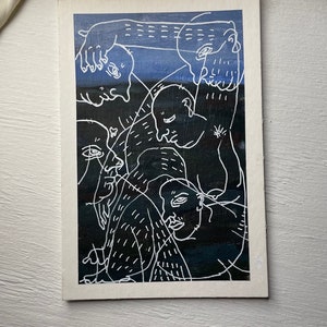 May include: A black and white line drawing of several faces, with a blue and black background. The faces are drawn in a stylized, abstract manner, with exaggerated features.