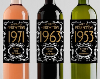 May include: Three wine bottles with black labels and gold lettering. The labels say "Aged to Perfection" and include the year 1971, 1963, and 1953. Each label also includes a personalized message with a name and age.