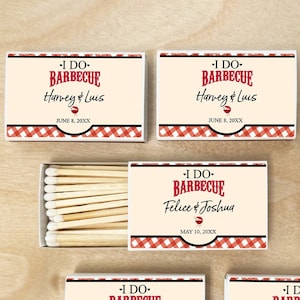May include: Six matchboxes with red and white gingham patterns. Each box has a white label with the text "I DO- BARBECUE" and the names of a couple, followed by the date of their wedding. The boxes are arranged in two rows of three.