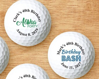 May include: Four white golf balls with personalized 40th birthday messages. The messages include "Aloha Forty", "Hello 40", "40 and Sexy", and "Birthday Bash".