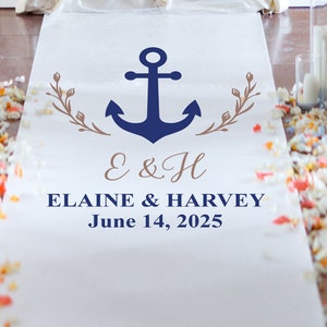 May include: A white wedding aisle runner with a navy blue anchor design, brown floral accents, and the names "Elaine & Harvey" with the date "June 14, 2025". The runner is decorated with scattered flower petals.