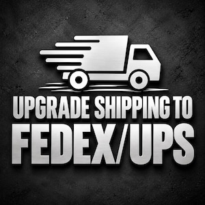 May include: A silver metallic graphic of a delivery truck in motion positioned above the bold silver text UPGRADE SHIPPING TO FEDEX/UPS, all set against a dark, textured background with a subtle drop shadow effect.
