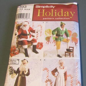May include: A Simplicity Holiday pattern collection featuring four costume designs. The designs include Santa Claus, an elf, and other holiday characters. The package has the text "Simplicity Holiday pattern collection" and "Andrea Schewe".