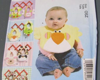 May include: A McCall's Crafts sewing pattern envelope for baby bibs, model M6661, size OSZ. The front features a photograph of a baby wearing a yellow bird-shaped bib, alongside illustrations of various animal-themed bib designs labeled A through H.