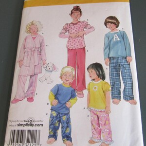 May include: A Simplicity sewing pattern envelope 2826 for children's sleepwear in size BB 4, 5, 6, 7, 8. The front features illustrations of various pajama styles including a striped robe, a star-print top with pants, a blue shirt with plaid pants, and floral sets.