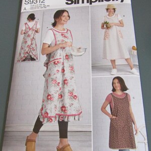 May include: Simplicity sewing pattern S9312 for aprons in sizes XS-XL. The package displays three variations: a floral print apron with ruffled trim, a solid white apron with floral pockets, and a brown patterned apron with a scoop neckline.