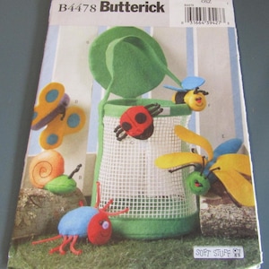 May include: Butterick B4478 sewing pattern envelope featuring Soft Stuff instructions for a green mesh basket and various felt insect and animal figures including a butterfly, snail, ladybug, bee, and dragonfly with colorful details.