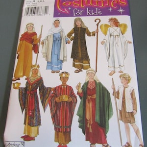 May include: A Simplicity sewing pattern envelope 4797 for kids' costumes, featuring illustrations of eight different historical and biblical outfits, including robes, tunics, an angel with wings, and various accessories like staffs, crowns, and vessels.