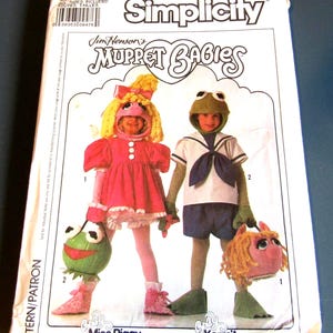 May include: Simplicity sewing pattern for making Muppet Babies costumes. The pattern includes instructions for making Miss Piggy and Kermit the Frog costumes. The pattern is from 1989.