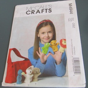 May include: McCall's Crafts pattern envelope M4944 for finger puppets and a small bag. The cover features a photograph of various felt finger puppets including a green frog, yellow bear, lion, blue figure, white rabbit, and tan dog, plus a red bag.