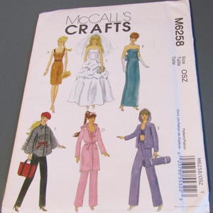 May include: A McCall's Crafts sewing pattern envelope featuring illustrations of various outfits, including a wedding dress, a leopard print dress, and a purple pantsuit. The envelope is white with the pattern number M6258.