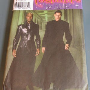 May include: A sewing pattern for a long black coat with a high collar. The pattern is for adults and is from Simplicity. The pattern number is 5386.
