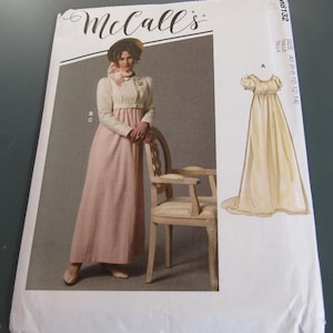 May include: A McCall's sewing pattern envelope featuring a woman in a pink and cream-colored Regency-style dress and jacket. The envelope also shows a drawing of a long, flowing dress. The McCall's logo is at the top.