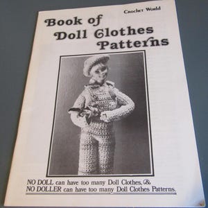 May include: A black and white book cover titled "Book of Doll Clothes Patterns" with a crochet doll wearing a crochet outfit. The text "CROCHET World" is at the top. The bottom of the cover reads "NO DOLL can have too many Doll Clothes, & NO DOLLER can have too many Doll Clothes Patterns."