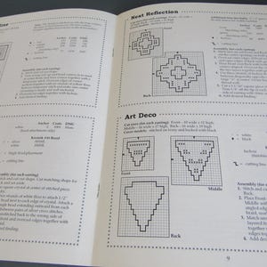 May include: An open book displaying cross-stitch patterns, such as "Sunset Skyline," "Crystal Lights," "Nest Reflection," and "Art Deco." The pages feature diagrams, instructions, and colour codes for each design.