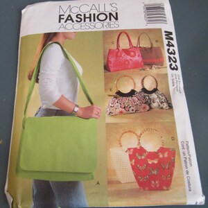 May include: McCall's Fashion Accessories sewing pattern envelope M43223 featuring illustrations of various handbags. The front shows a lime green messenger bag, a pink floral tote, a brown bag, and three bags with round bamboo handles.