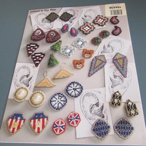 May include: A selection of handmade earrings in diverse shapes and designs. The earrings showcase a variety of colours, including red, blue, green, and white. Some earrings have pearl accents, while others feature geometric patterns. The earrings are displayed on a printed background.