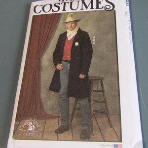 May include: A McCall's costume pattern package featuring a man in a cowboy costume. The package has the word "COSTUMES" in large, stylized letters. The man is wearing a black coat, red vest, jeans, and a cowboy hat. The package also includes the size and the text "Designed and printed in USA."