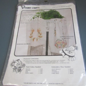 May include: A Vogart Crafts permanent press lace trimmed scarf kit for embroidery or painting, style #84138 Orange Jacobean. The package includes a 13 in. x 40 in. scarf, lists paint colors, embroidery floss requirements, and instructions.