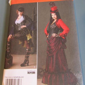 May include: Simplicity sewing pattern number 1819 HH for a steampunk-inspired costume. The pattern includes a corset, skirt, jacket, and hat. The model is wearing a red jacket, a black corset, a burgundy skirt, and a red top hat with feathers.
