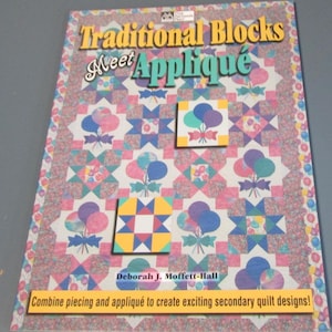May include: A book cover titled "Traditional Blocks Meet Appliqué" featuring a colorful quilt design. The quilt design includes squares with balloon and star patterns in shades of pink, blue, and yellow. The author's name is Deborah J. Moffett-Hall.