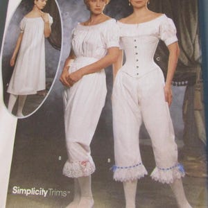 May include: A white vintage sewing pattern featuring three women in period clothing. The pattern includes a long dress, a top with bloomers, and a corset. The text "Simplicity Trims" is visible at the bottom of the image.