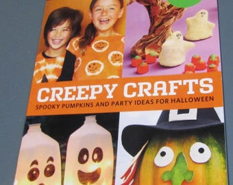 May include: A magazine cover with the title "Creepy Crafts" and the Disney FamilyFun logo. The cover features images of children, Halloween crafts, and a smiling pumpkin with a witch hat. The magazine promotes spooky pumpkins and party ideas.
