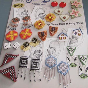 May include: A selection of handcrafted earrings and small crafts, including dice, hearts, and geometric shapes. The earrings showcase diverse designs, like houses, flowers, and abstract patterns. The colour scheme incorporates red, yellow, blue, and white.