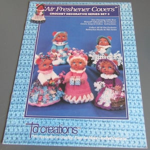 May include: A printed pattern for crocheted air freshener covers. The cover designs feature small bear figures in various outfits, including dresses and bonnets. The text reads "Air Freshener Covers" and "Crochet Decorative Series Set 3".