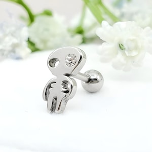 May include: Silver alien body piercing with a clear crystal on the head. The piercing is a barbell style with a small ball on the end.
