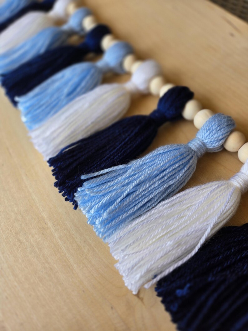Carolina blue and white tassel banner styled for North Carolina college students, ideal for dorm room wall decorations, college parties, and alumni gatherings.