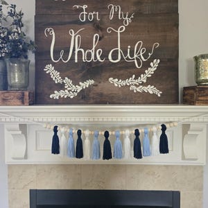 College spirit tassel garland in Carolina blue and white, great for North Carolina game day celebrations, tailgates, and graduation events.