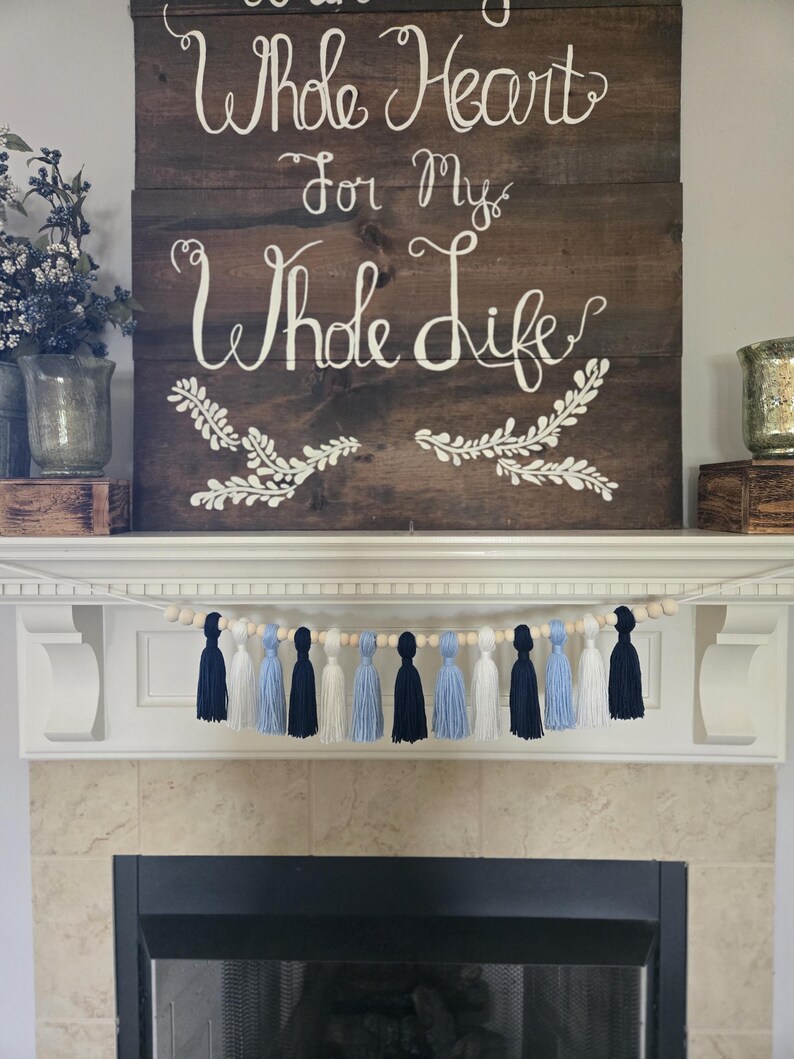 College spirit tassel garland in Carolina blue and white, great for North Carolina game day celebrations, tailgates, and graduation events.