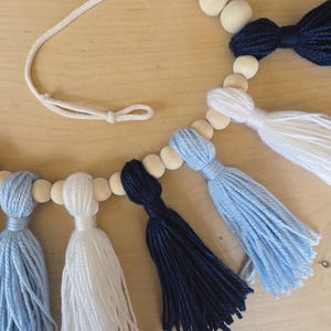 Handmade Carolina blue and white tassel garland for North Carolina college dorm and party decor, perfect for game days, tailgates, dorm rooms, and graduation celebrations
